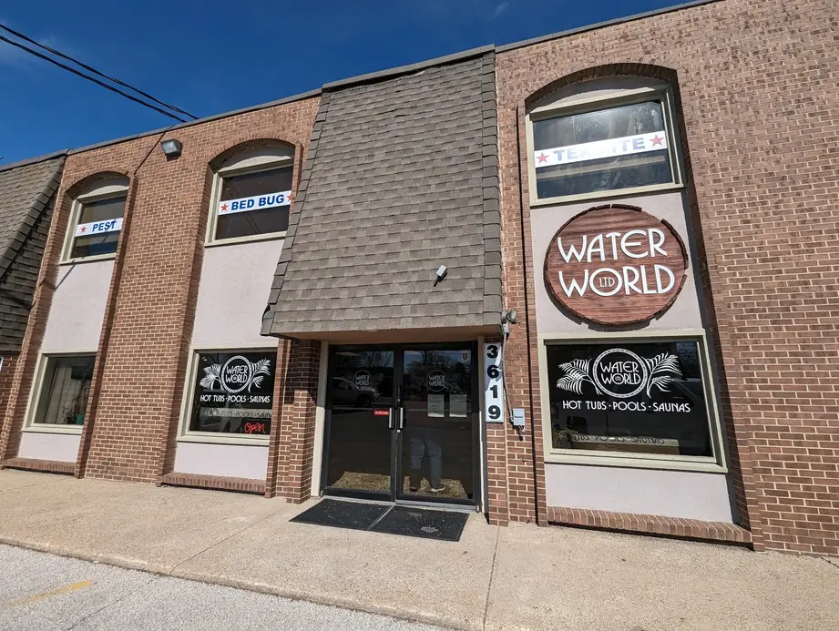 Brick storefront at 3619 Douglas Ave with the Water World sign in the window